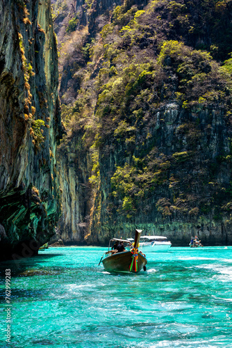 A boat sailing on turquoise water. Phi Phi Island in Thailand.