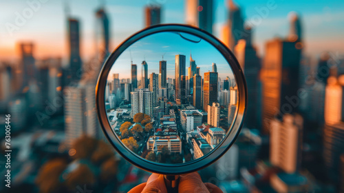 Magnifying glass in hand with city skyline background,