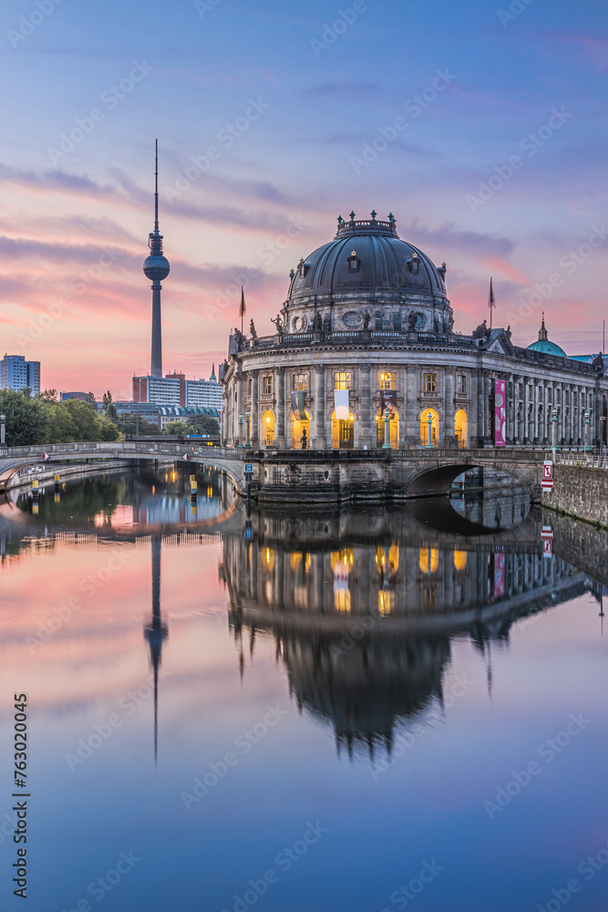 River Spree in the center of Berlin with Bode Museum and TV tower in the morning. Reflections of the illuminated buildings in the Neo-Baroque architectural style shortly before sunrise.