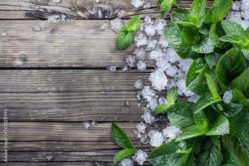 Background with natural iced mint on wooden table with crushed ice andleaves and plant around. Top view. Horizontal composition. photo