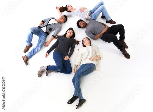 Above view of a happy group of friends lying on white floor.