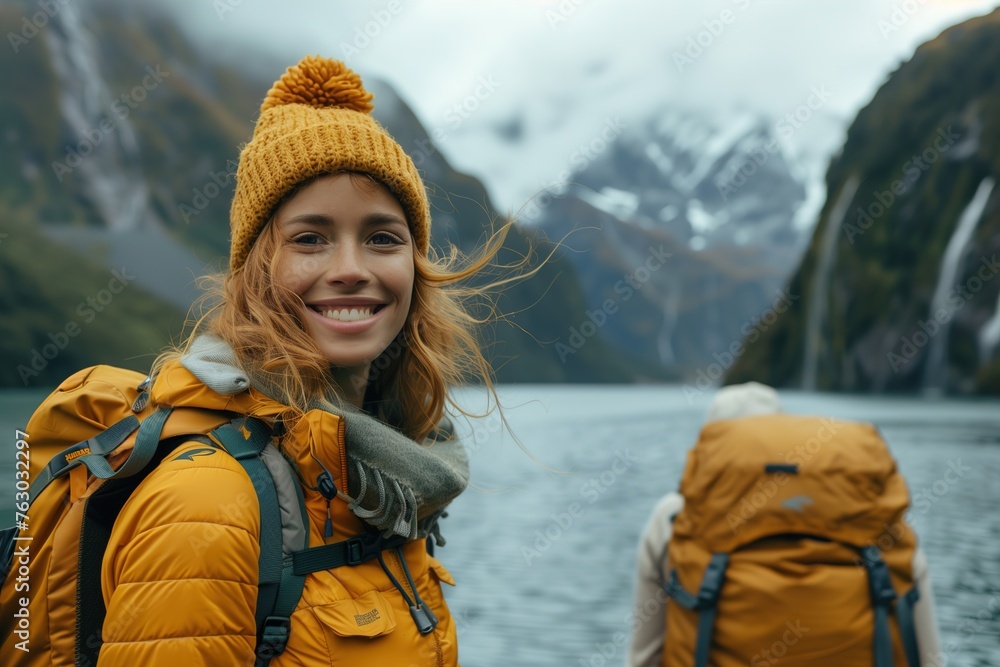 Woman Standing by Lake With Mountains in Background Woman Standing by Lake With Mountains in Background