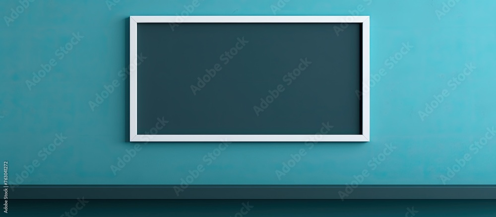 A rectangular picture frame hangs on an azure wall, creating symmetry. The electric blue color contrasts with the aqua background, resembling a computer monitor accessory or gadget A rectangular picture frame hangs on an azure wall, creating symmetry. The electric blue color contrasts with the aqua background, resembling a computer monitor accessory or gadget