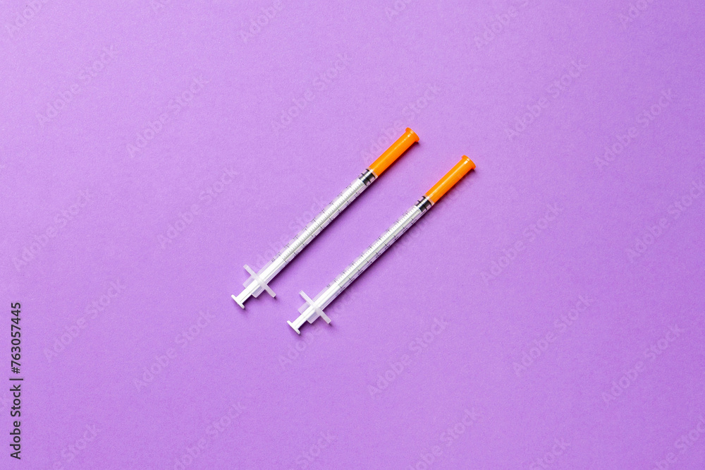 Top view of insulin syringes ready for injection on colorful background. Diabetic concept with copy space Top view of insulin syringes ready for injection on colorful background. Diabetic concept with copy space