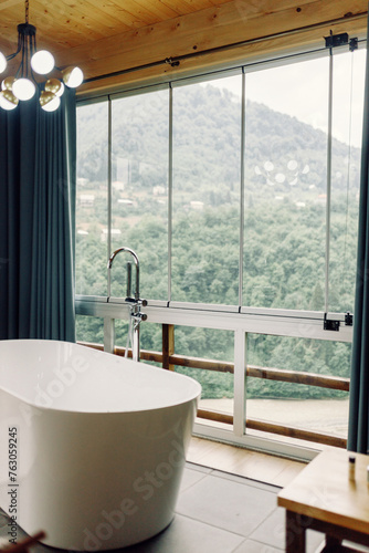 beautiful view of the mountains from the bathroom. modern interior in a house in nature