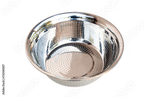 Stainless steel basin washing vegetables on white background.
