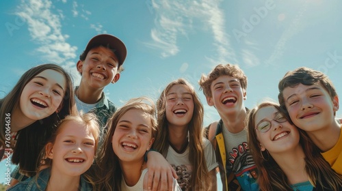friendship, summer vacation, nature and people concept - group of smiling teenagers standing over blue sky and grass background