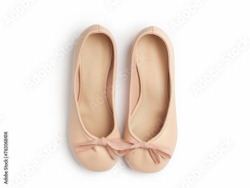Top view of elegant beige ballet flats with bows isolated on white, stylish and simple women's footwear.