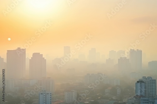 The sun rises over a cityscape covered in a haze  creating a moody and atmospheric urban morning. Hazy Sunrise over Urban Cityscape with Buildings