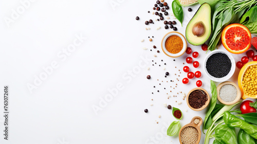 Healthy food clean eating selection, fruit, vegetable, seeds, superfood, cereal, leaf vegetable on white background. Top view. Copy space.