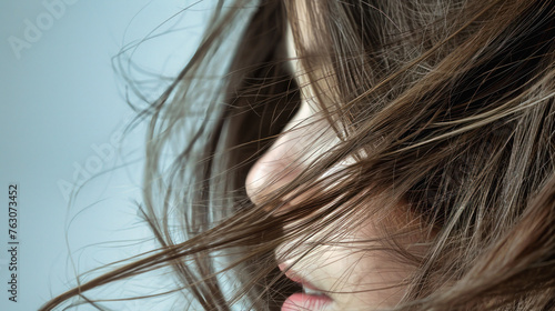 Close-up view of a womans long, wavy hair blowing in the wind, showcasing hair care and style