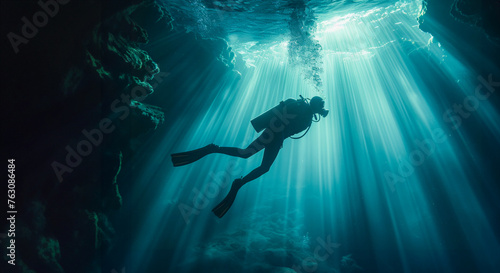 Scuba deep sea diver swimming in a deep ocean cavern