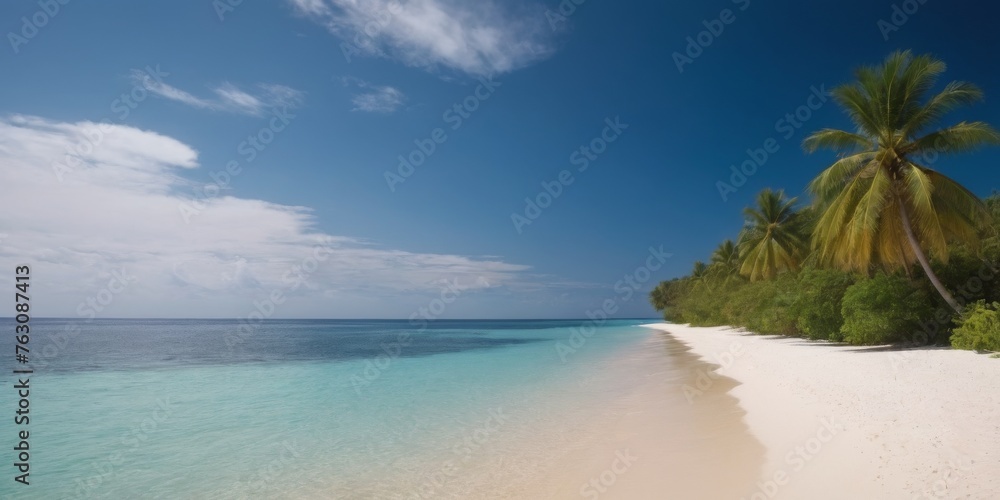A beautiful beach with a clear blue ocean and a few palm trees. The sky is cloudy, but the beach is still a peaceful and relaxing place