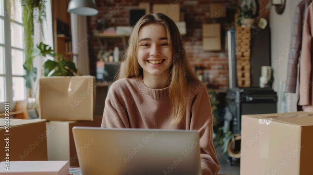 Small business owner is working on a laptop in the warehouse Small business owner is working on a laptop in the warehouse
