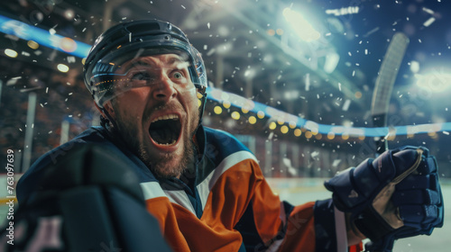 A hockey player exudes shouts of joy amidst the hockey stadium's ambiance, celebrating victory with intense emotions after winning the game, clad in a orange hockey jersey.