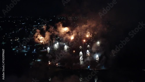 Group of exploding firework at night sky of Dominican Republic. Aerial top down shot. photo