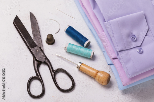 Folded shirts, scissors and other tools for home clothing repair