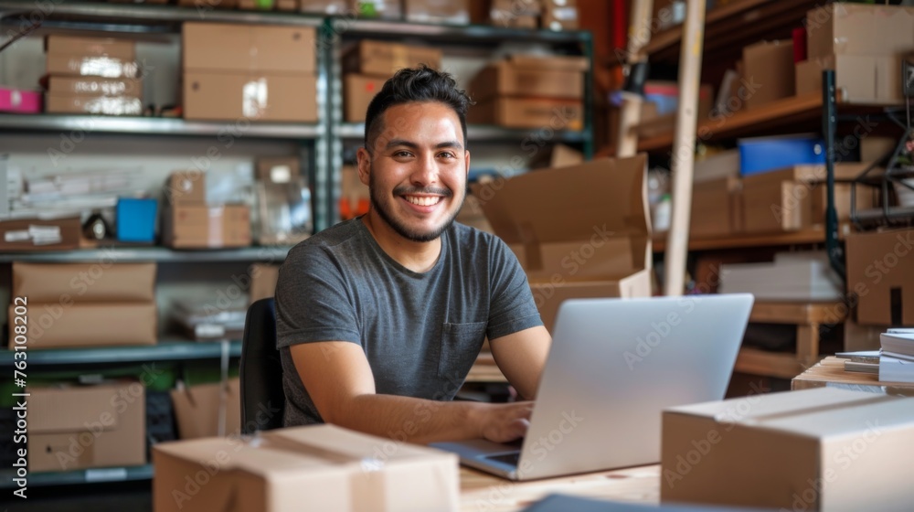 Small business owner is working on a laptop in the warehouse Small business owner is working on a laptop in the warehouse