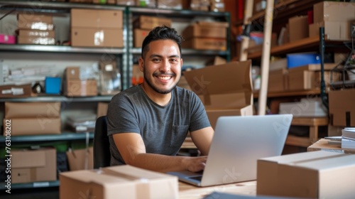 Small business owner is working on a laptop in the warehouse © Michael