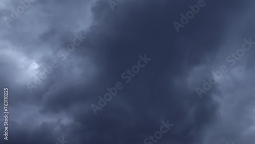 The great mass of gray and black clouds recedes and the radiant light illuminates the sky photo