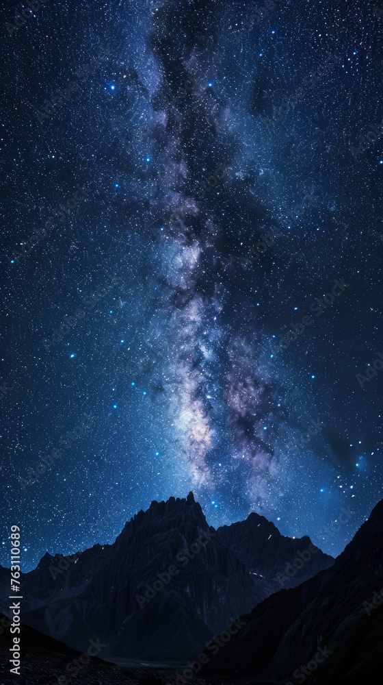 Starry night sky over mountain peaks