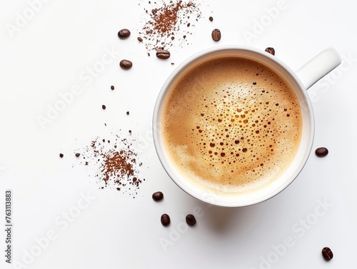 Top view of a coffee cup surrounded by beans and scattered grounds on a white surface.