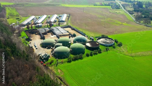 Biogas plant and farm in fields. Renewable energy from biomass. Agriculture prepared for Green Deal. Aerial view to Czech industry. Sustainable development in European Union. 