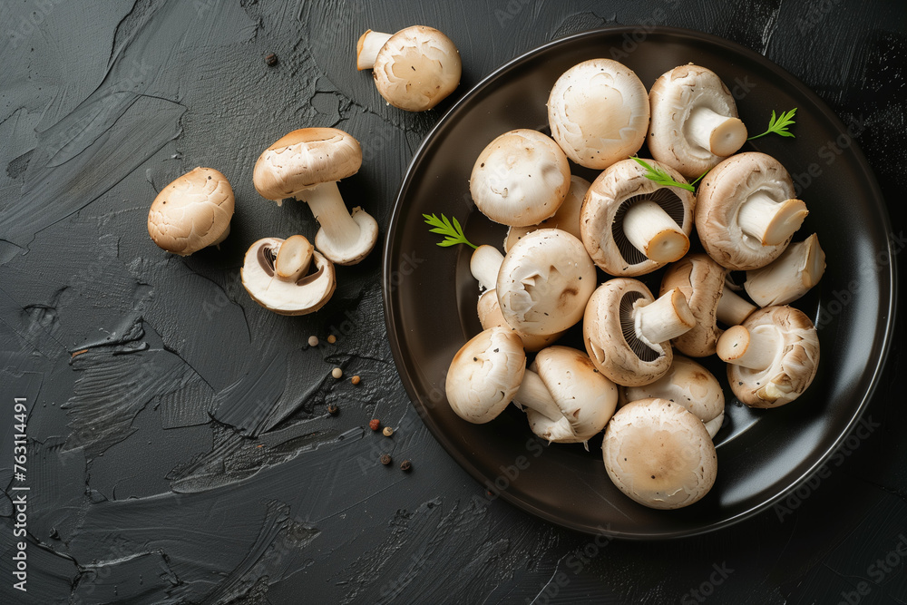 Top View Close-Up Champignon Mushrooms Plate. Top view of champignon mushrooms on a black plate, ideal for culinary themes. Top View Close-Up Champignon Mushrooms Plate. Top view of champignon mushrooms on a black plate, ideal for culinary themes.