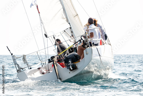 Sailing boat in light wind during regatta competition photo
