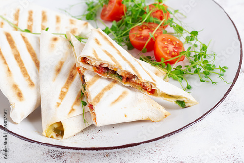 Tasty breakfast with lavash. Mexican cuisine. Trending food with pita bread, cheese, tomatoes and spinach