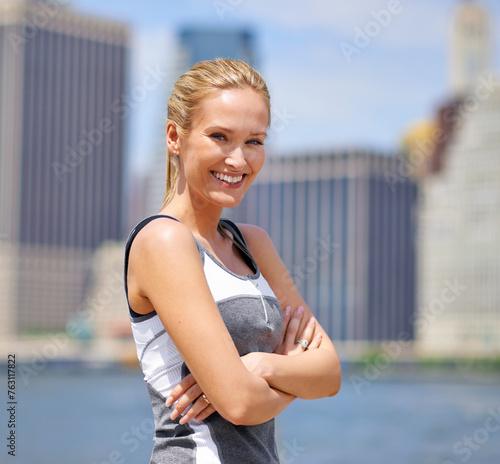 Portrait, woman and happy at river side with city on sport clothes for walk, fitness and healthy mindset in New York. Confident, female person and smile with self care in summer and hot weather