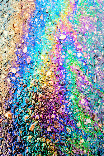 Leaked Gasoline Oil Slick or Petrol Rainbow Enviromental leak On Tarmac Road