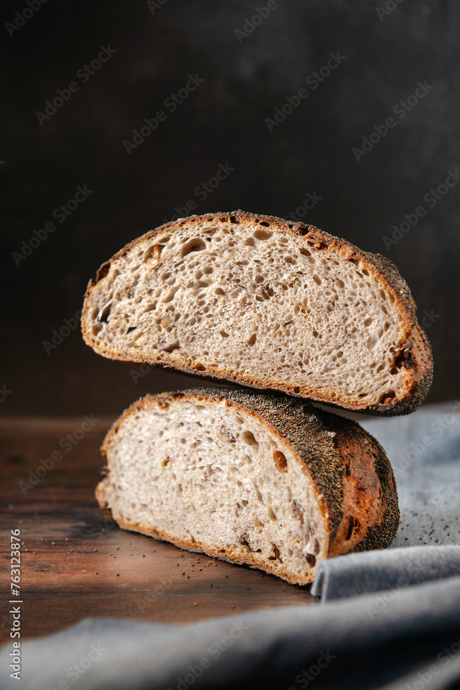 Homemade sourdough bread. Fresh Sourdough bread cut in half,  on a black background. 