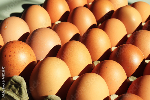 Chicken eggs neatly arranged on egg box.  with sunlight in the morning. as background and wallpaper photo