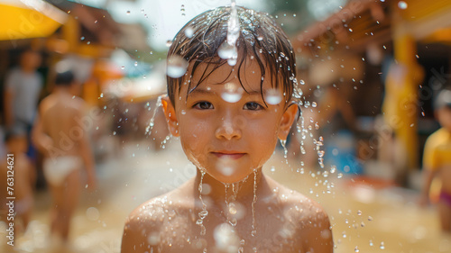 Happy Thai boy at the Songkran street watering festival. 
