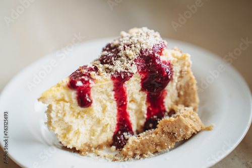 Delicious dessert - homemade cheesecake with berry sauce