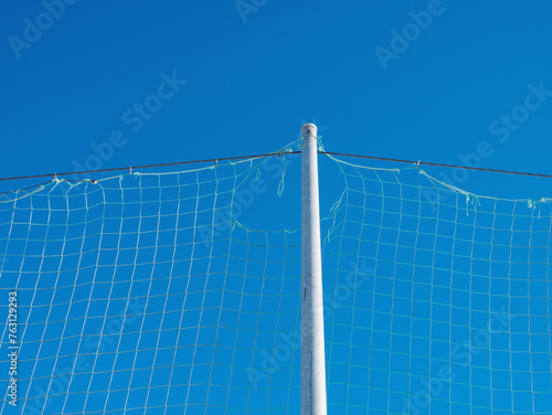 weathered old nylon net against blue sky background