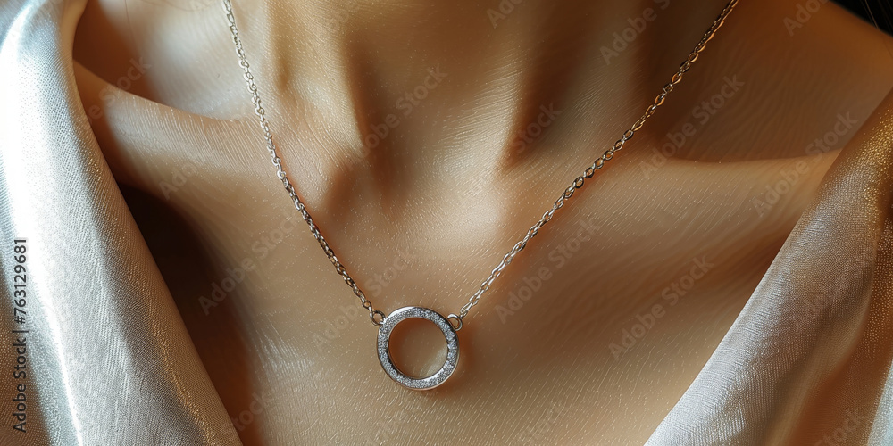 This photo captures a close-up view of a woman neck adorned with an elegant gold necklace. The necklace features a simple circular pendant, adding a touch of sophistication to the overall look This photo captures a close-up view of a woman neck adorned with an elegant gold necklace. The necklace features a simple circular pendant, adding a touch of sophistication to the overall look