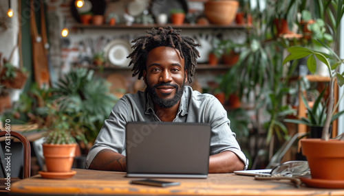 Close up of black american man in white tshirt sitting and typing, working on laptop keyboard in bright scandinavian interior of living room. Concept of freelance work at home, studying at home.