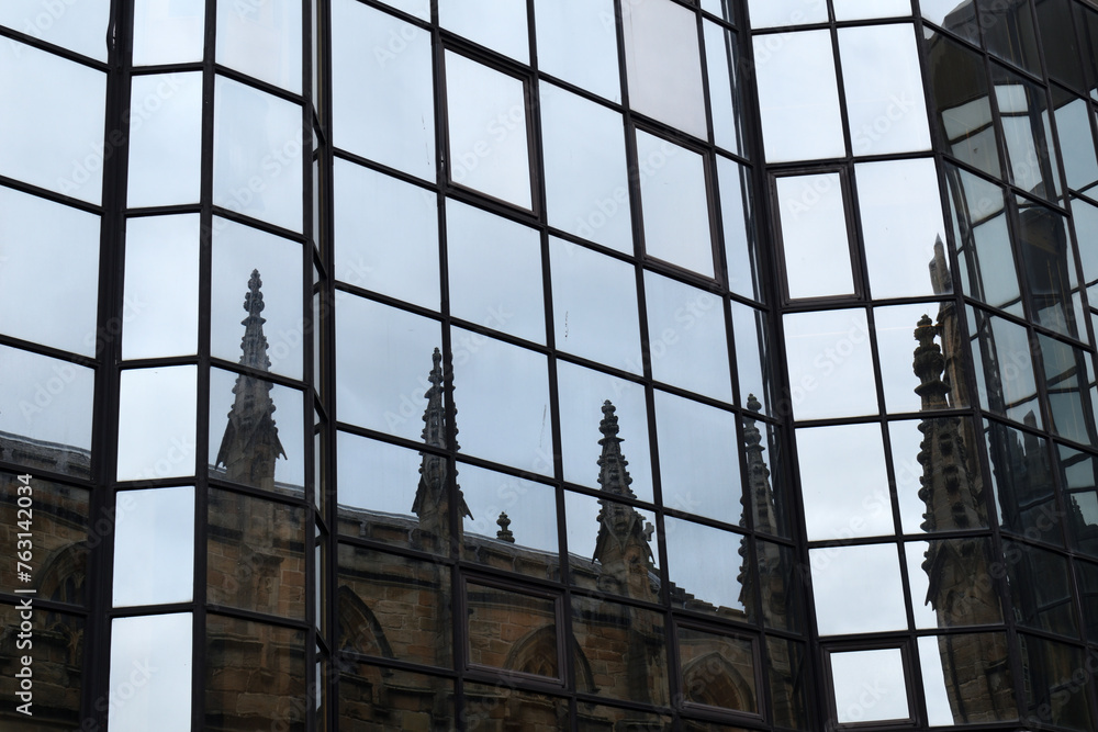 Reflections of Old Stone Church in Windows of Modern Office Building Reflections of Old Stone Church in Windows of Modern Office Building