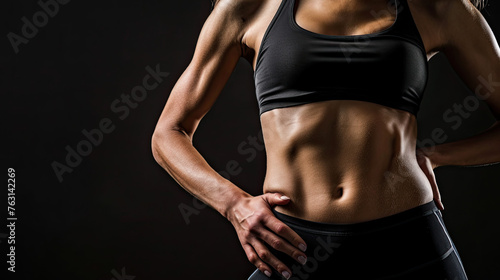 Woman with ABS on black background
