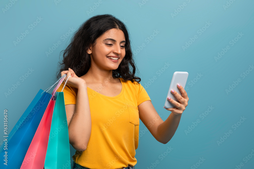 Woman admiring her phone with a smile Woman admiring her phone with a smile