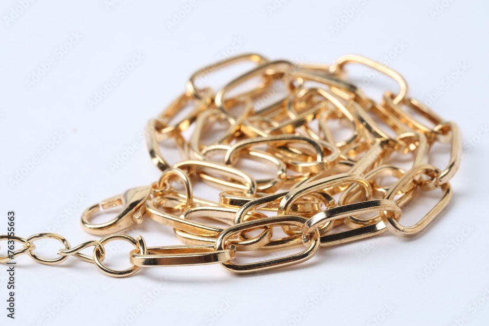 One metal chain on white background, closeup. Luxury jewelry One metal chain on white background, closeup. Luxury jewelry