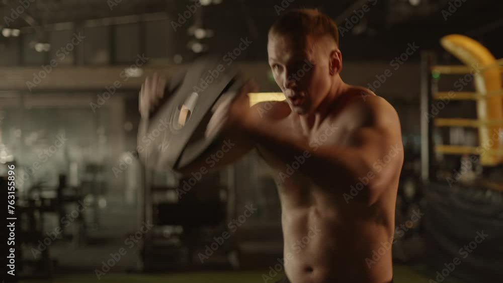 athletic men doing exercises in the gym. a naked muscular torso Plate press athletic men doing exercises in the gym. a naked muscular torso Plate press