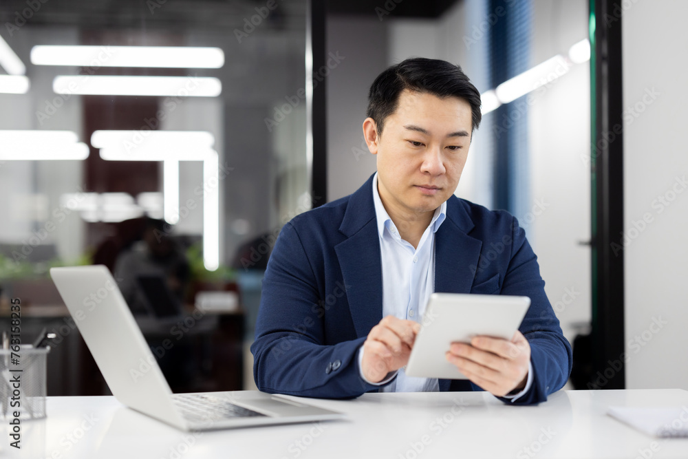 Professional businessman using tablet in modern office Professional businessman using tablet in modern office