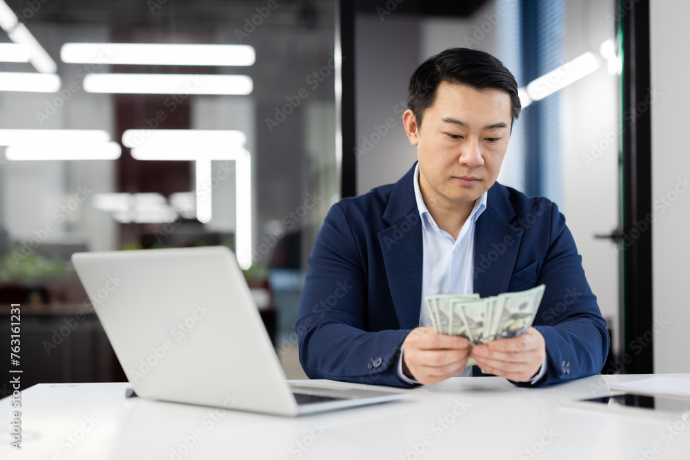 Businessman analyzing budget at modern office desk Businessman analyzing budget at modern office desk