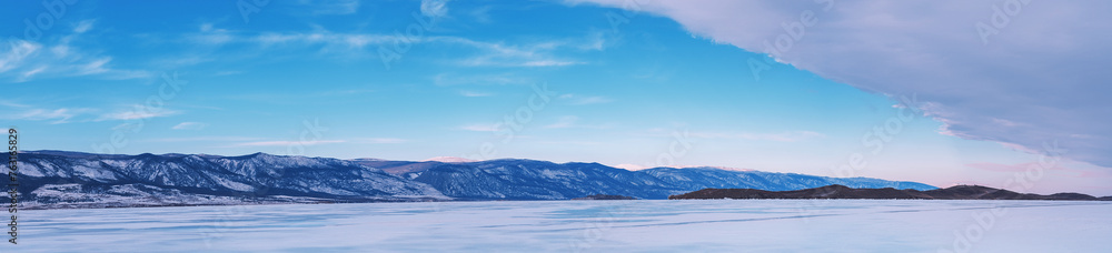 Beautiful winter landscape with mountains and Lake Baikal in Siberia at sunsut. Natural background with copy space. Web banner.