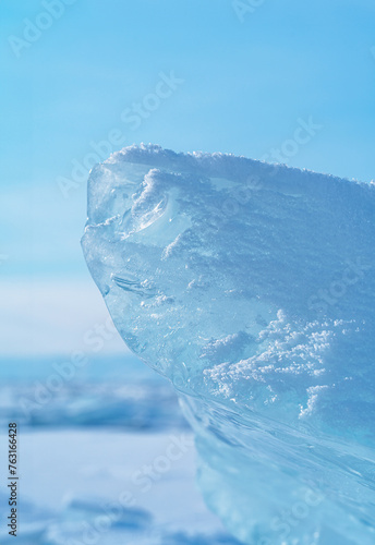 Ice hummocks against blue sky on Baikal Lake. Transparent blue ice floe. Great backdrop for your design with copy space.