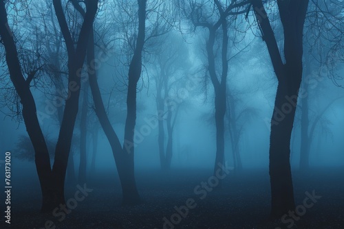 A fog-covered forest with numerous silhouetted trees, creating a mysterious and eerie atmosphere