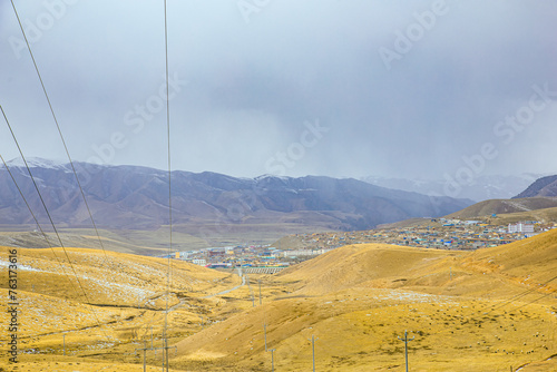 Gannan Tibetan Autonomous Prefecture, Gansu Province-Grassland under the snow-capped mountains photo